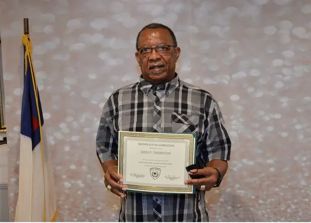 BCBC student holding a course completion certificate